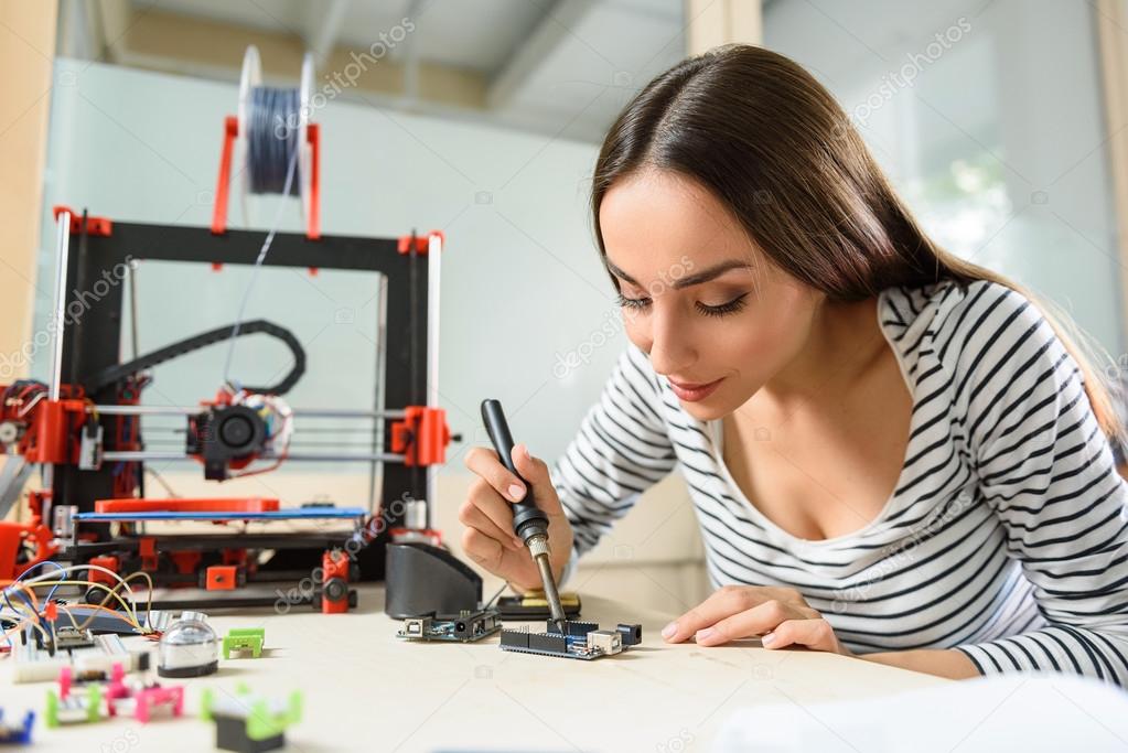 Smart young woman testing 3d printing components