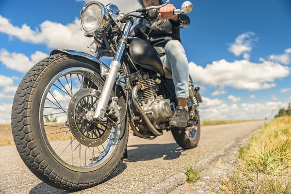 Jovem montando sua moto na estrada aberta — Fotografia de Stock