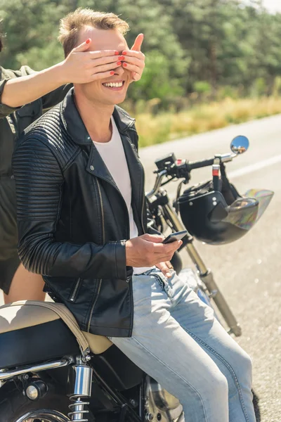 Young man sitting on his motorbike — Stock Photo, Image