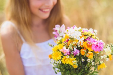 Joyful female kid adores field bouquet clipart