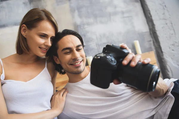 Jovem fotógrafo sorridente com uma câmera — Fotografia de Stock