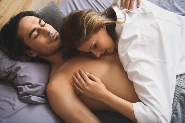 Young couple resting in a bed — Stock Photo, Image