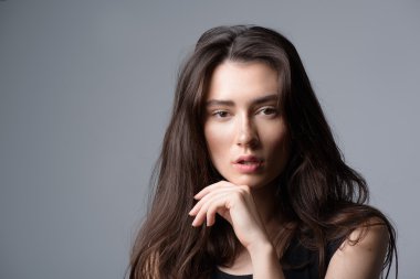 woman posing in the studio, isolated on light grey background with copyspace