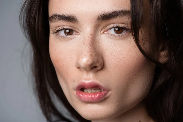 Woman face isolated on light grey background — Zdjęcie stockowe