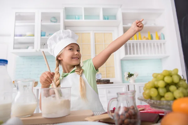 Joyful child preparing dough in kitchen — Stock Photo, Image