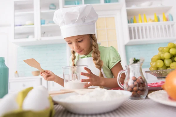 Cute child making dough at home — Stock Photo, Image