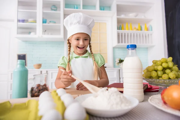 Pretty child cooking with enjoyment — Stock Photo, Image