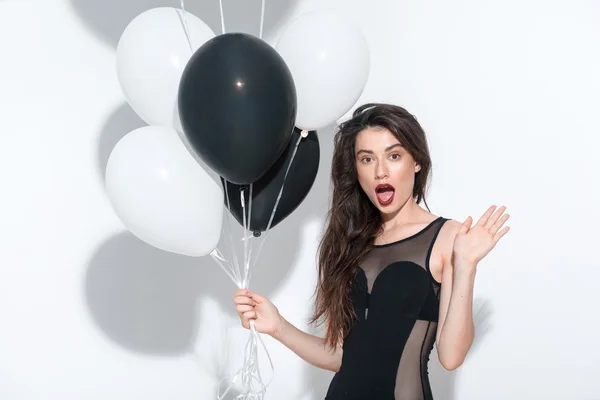 Waist up of a beautiful seductive model holding balloons — Stock Photo, Image
