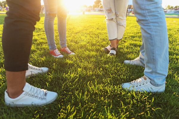 four friends in sneakers outdoors