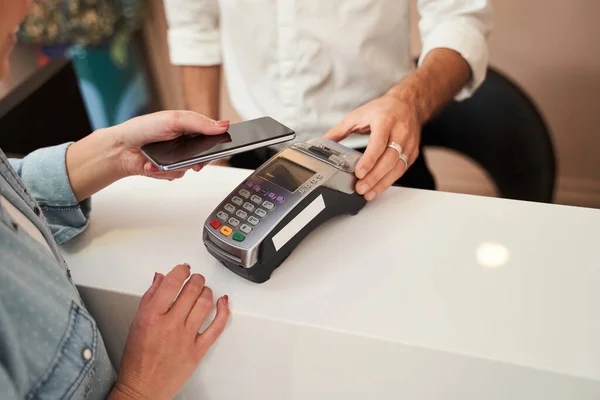 Woman paying with card contactless