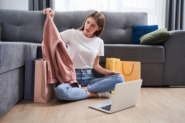 Girl looking at her purchase — Stock Photo, Image