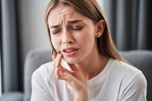 Girl touching her cheek with her fingers — Stock Photo, Image