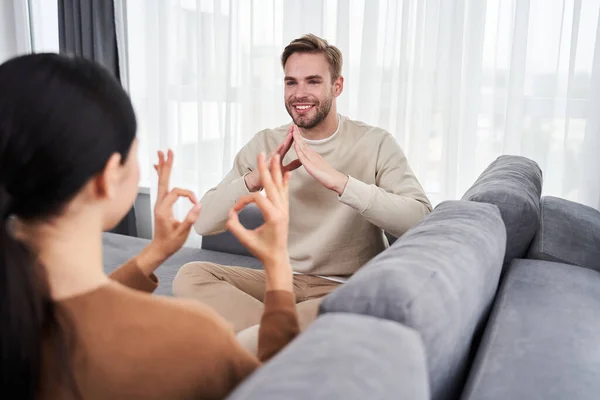 Couple speaking with each other with gesture language