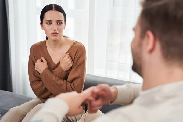 Woman telling something nonverbal to her husband