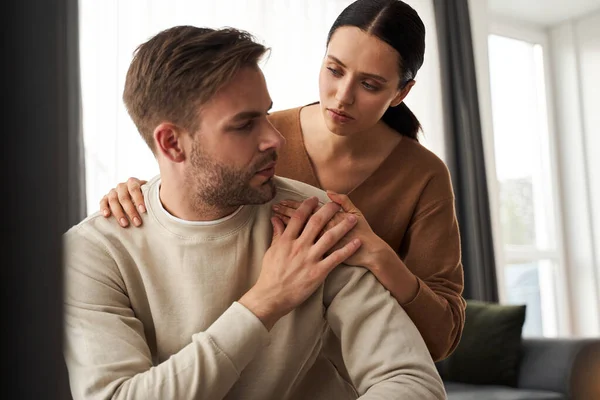 Wife caring and supporting to her upset husband