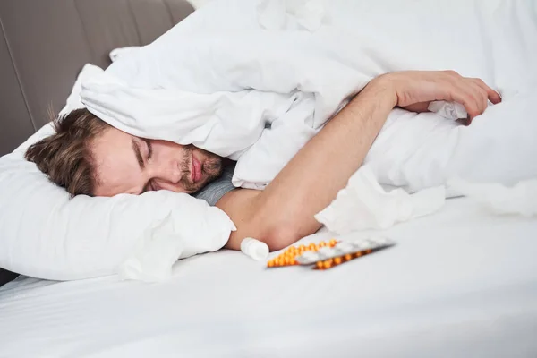 Sick man lying on the bed