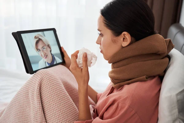 Woman feeling unhealthy while chatting with her doctor — Stock Photo, Image