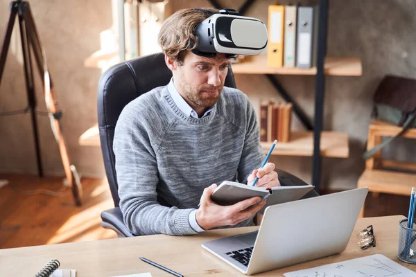 Man writting something at his notebook — Stock Photo, Image