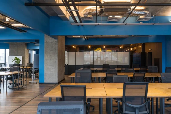 Rental office for IT workers with empty computer tables