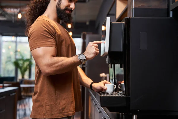 Man standing near the coffee machine