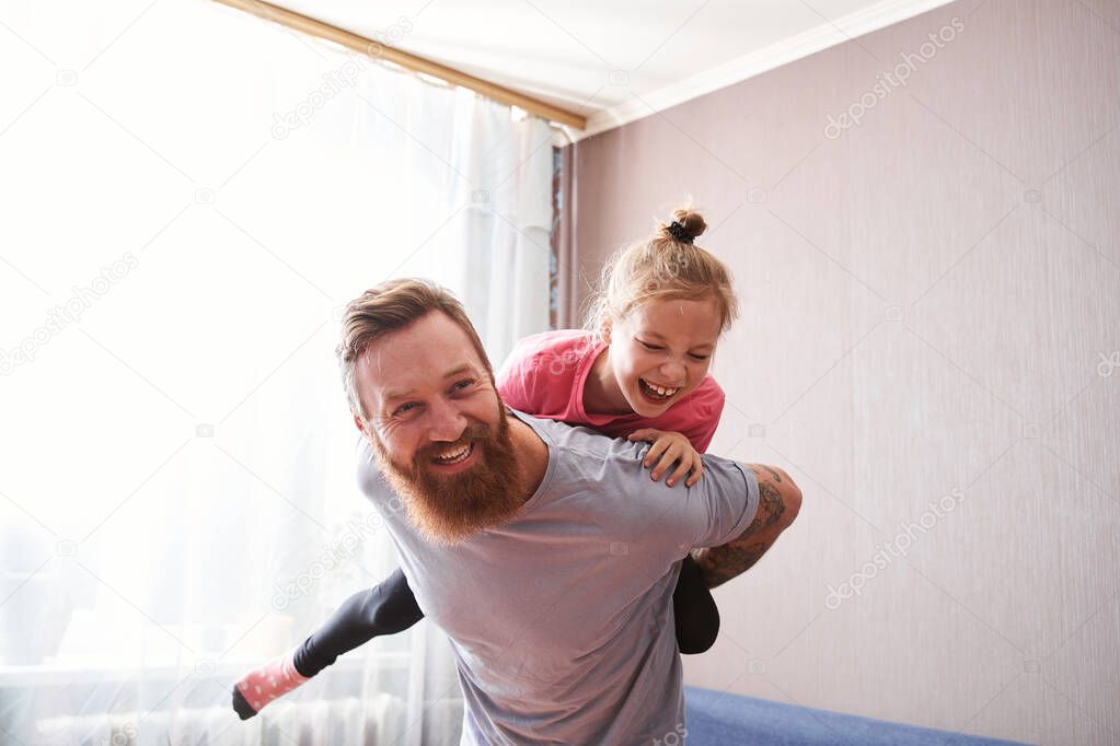 Father and his lovely daughter are laughing out loud