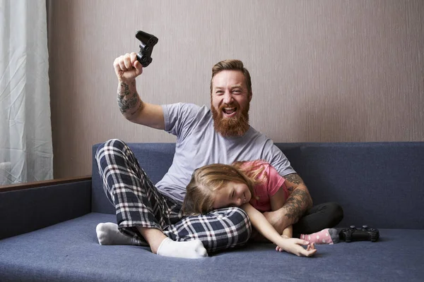 Otec se raduje a jeho dcera leží na kolenou — Stock fotografie
