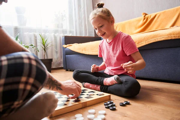 Father and his blonde daughter playing checkers — Stock Photo, Image