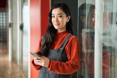Koyu saçlı, koruyucu maske takan başarılı bir bayan öğrenci.