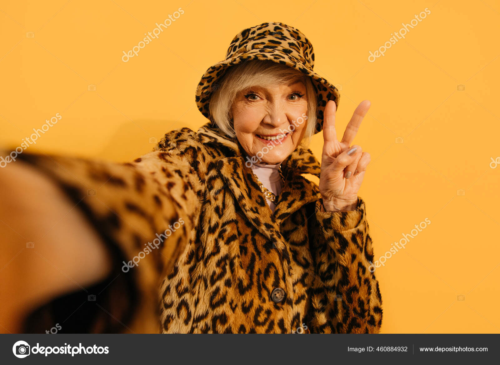 Woman wearing total leopard look taking selfie and showing peace