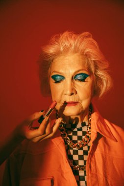 Stüdyoda dudak boyayan bir kadın bekliyor.