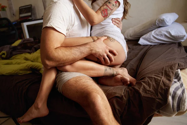 Woman sitting at the knees of her man and embracing with him — Stock Photo, Image