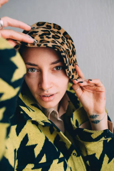 Woman with septum at her nose holding with her hands her leopard panama — Stock Photo, Image