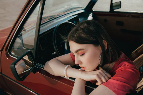 Girl sitting the drivers seat at her car and relaxing with closed eyes — Stock Photo, Image