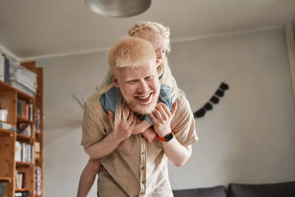 Mädchen huckepack mit ihrem Vater und umarmt ihn zärtlich — Stockfoto