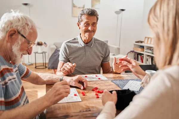 Seniors spending time together playing at the retro board game — Stock Photo, Image
