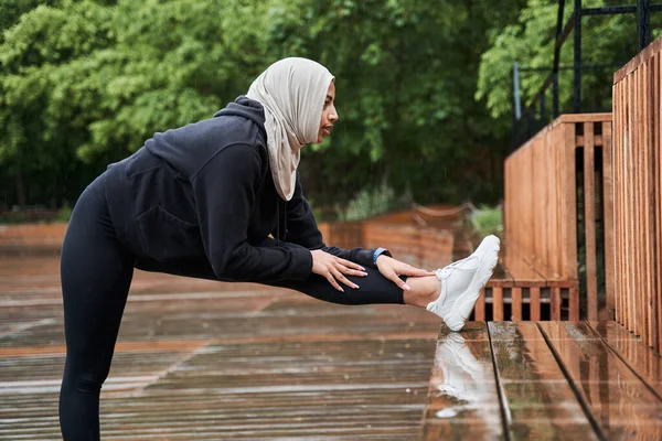 Muslim woman in sportswear exercising in the morning and feeling healthy