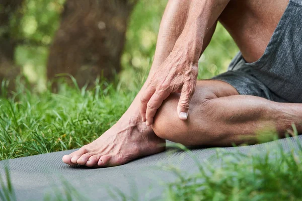 Mann streckt seinen Körper vor dem Training im Wald — Stockfoto