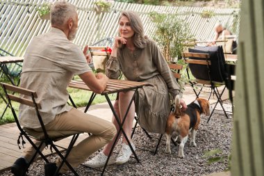 Man sitting in front of his beloved wife while enjoying time together at the cafe