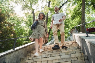 Happy mature couple resting on the nature