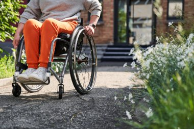 Female person with loss of leg function sitting at the special armchair