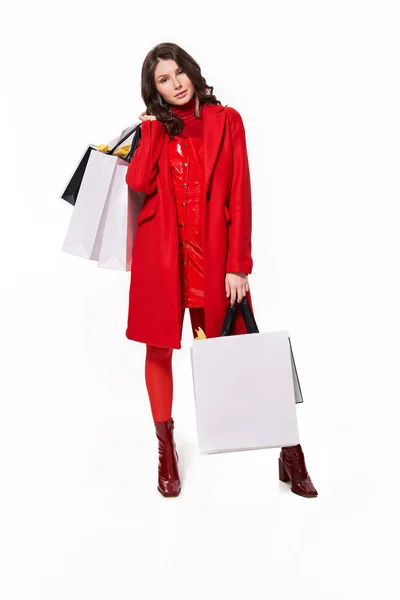 Girl standing with a lot of shopping bags over white background — Stock Photo, Image