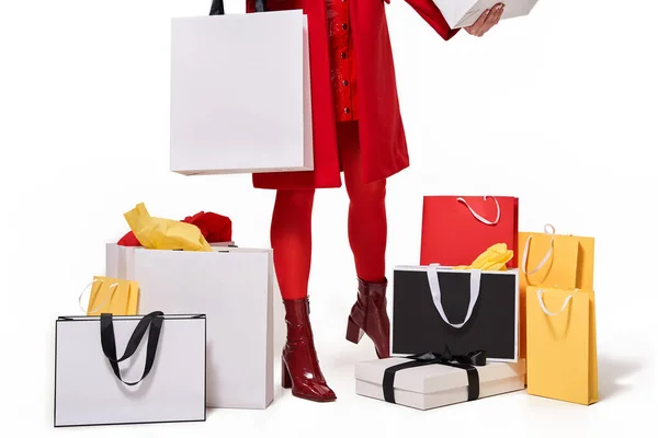 Woman standing with bags and presents at studio — Stock Photo, Image