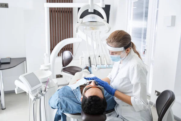 Man having teeth whitening by dental UV whitening device — Stock Photo, Image