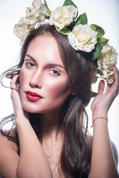 Girl in a wreath of beautiful flowers — Stock Photo, Image