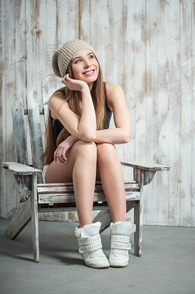 Beautiful hipster woman is sitting on the chair — Stock Photo, Image