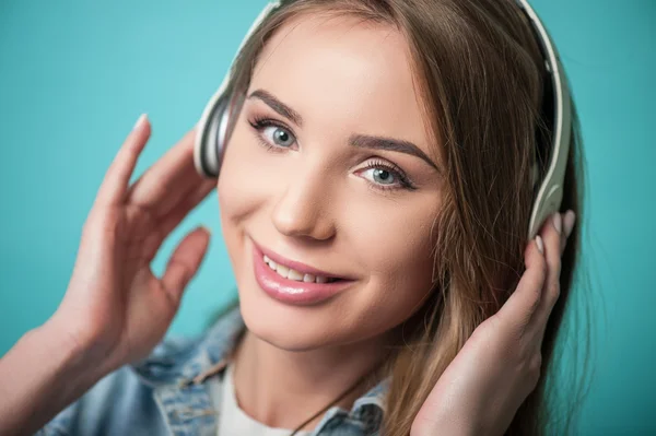 Cheerful Hipster woman is wearing headphones and listening to music — Stock Photo, Image