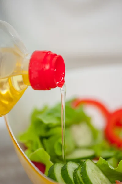 Someone is making healthy tasty salad filling it up — Stock Photo, Image