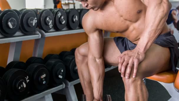 Attractive young man is exercising with heavy iron equipment — Stock Video