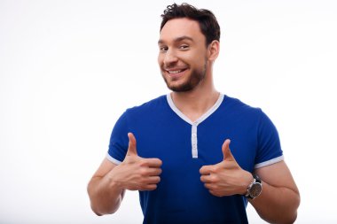Attractive young man is expressing positive emotions