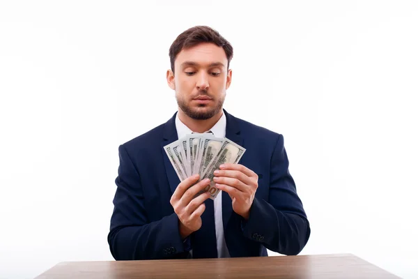 Handsome young man is calculating his savings — Stockfoto